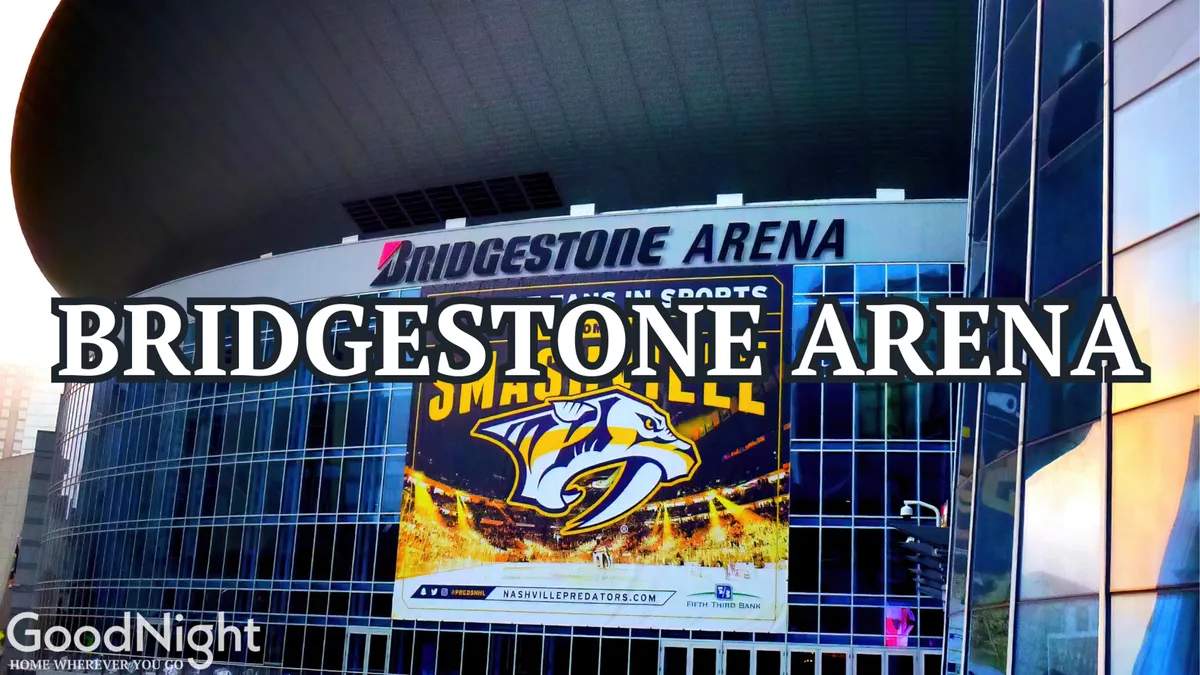 This image captures the exterior of Bridgestone Arena, featuring its recognizable signage and banners, and the modern architectural lines that signal its vibrant role as a hub for sports and concerts in downtown Nashville.